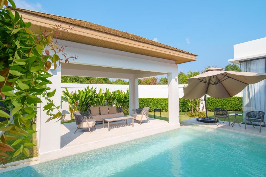 Villa pool and covered lounge cabana in daylight