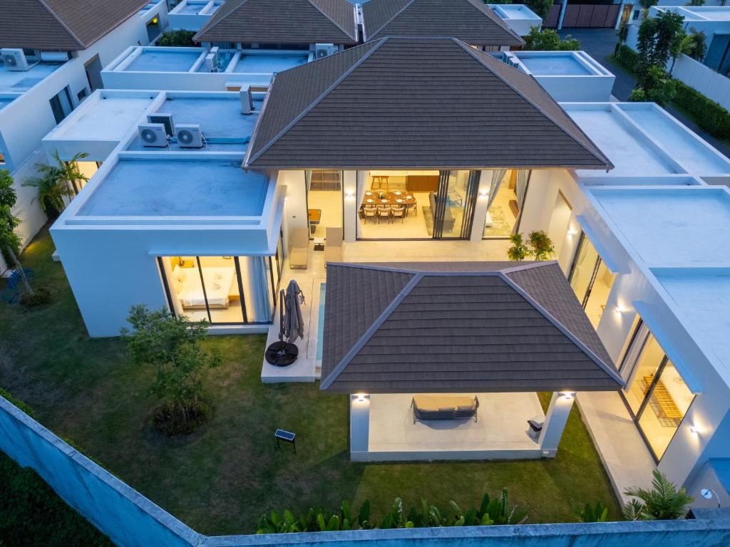 Aerial dusk view of the villa roofline and lit interior