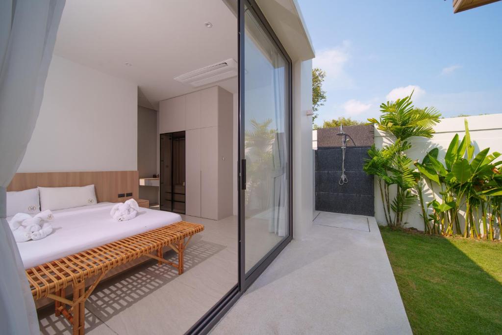 Villa bedroom opening onto a private outdoor shower
